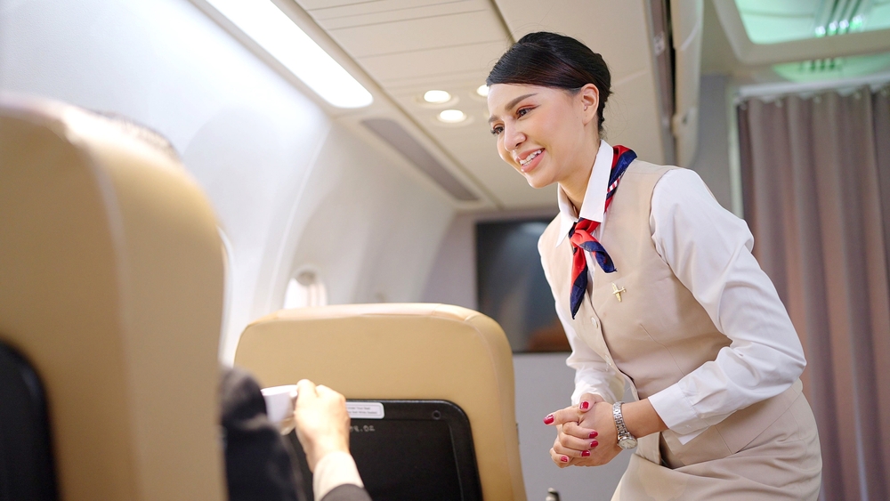 asian flight attendant addressing customer, tourism