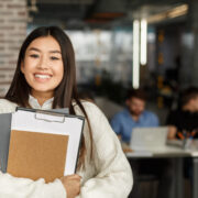 Happy girl in modern library smiling to camera
